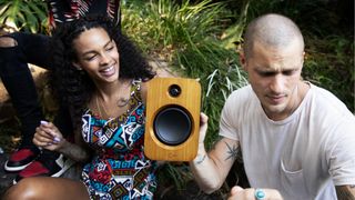 House of Marley Get Together Solo speaker, held up by a man and woman