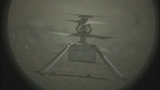 A photo of NASA's Martian helicopter Ingenuity sitting on the red sands of Mars taken by the Perseverance rover.