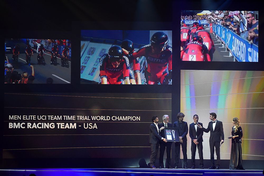 BMC Director Fabio Baldato, Daniel Oss and Manuel Quinziato get the team time trial World Championship prize from Brian Cookson.