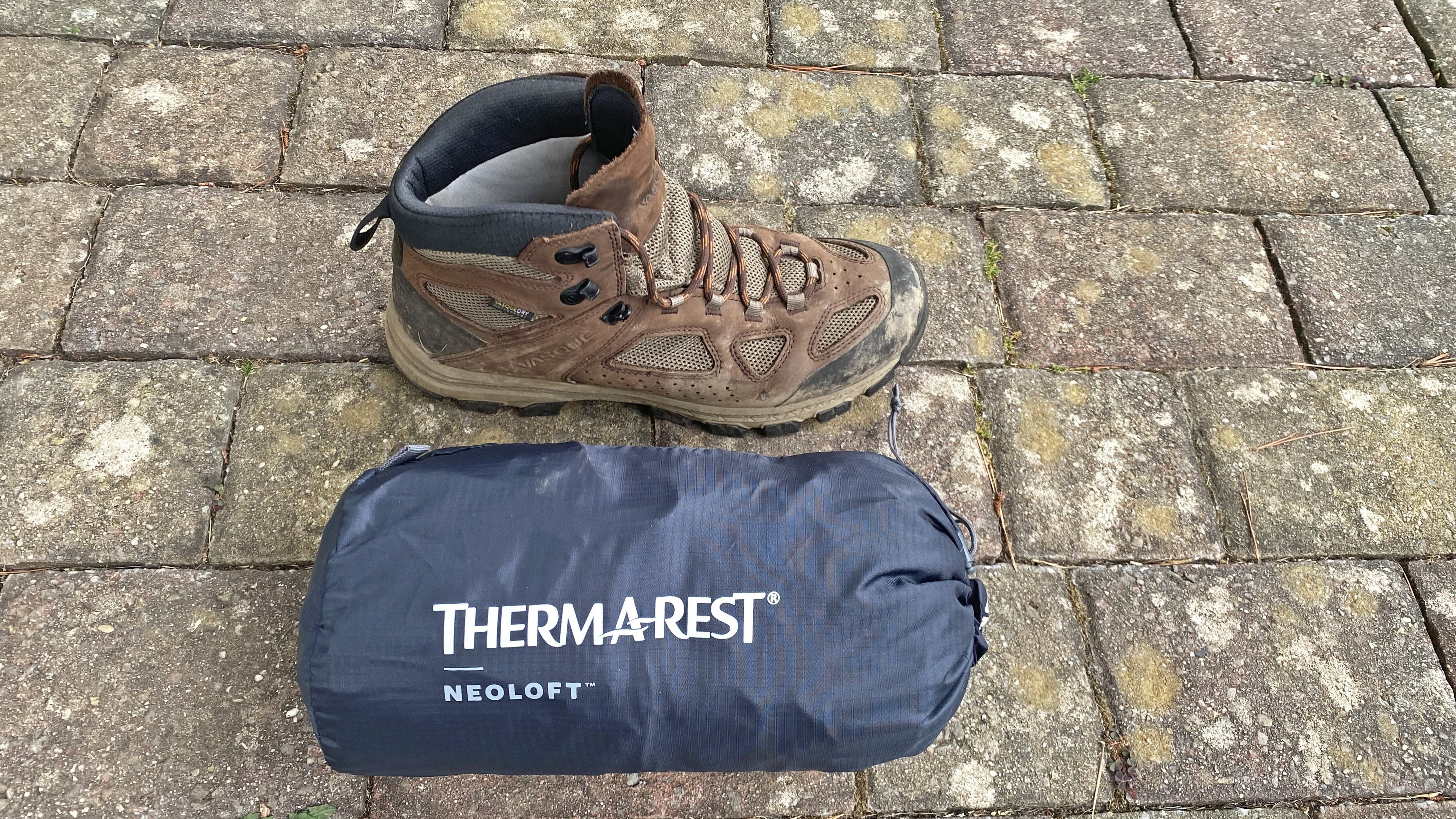 Therm-a-Rest NeoLoft shown packed away, with a hiking boot for size perspective