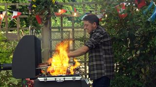 Matty Barton's hands are swallowed up by a fireball as he tends to Marlon's BBQ at the Woolie.