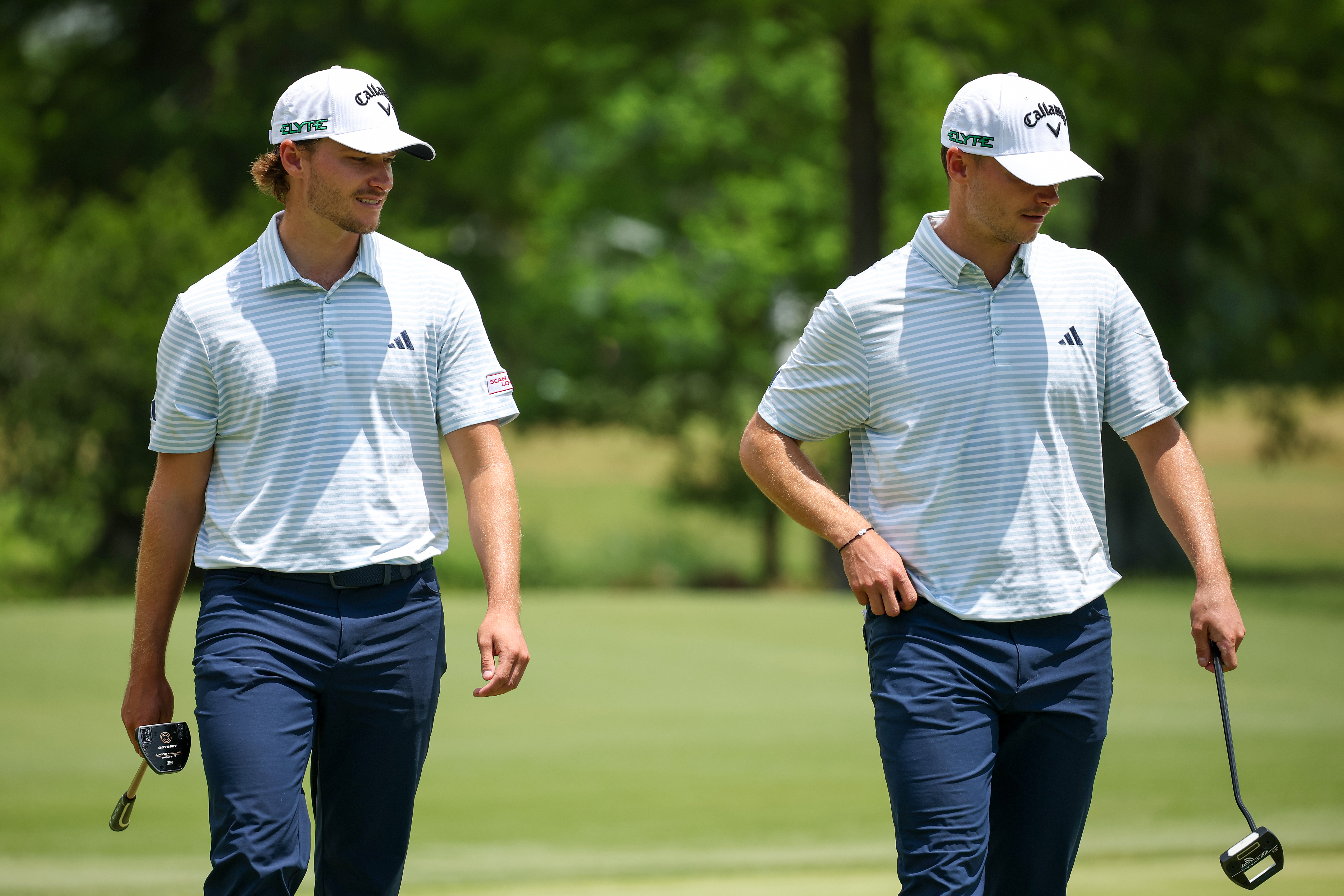Rasmus and Nicolai Hojgaard walk on the green