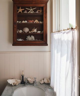 what color drapes curtains are best for summer, bathroom with vintage cabinet on the wall, marble sink, white cafe style curtains