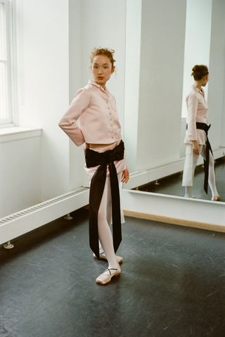 Sandy Liang model in pink satin top, skirt, and ballet flats