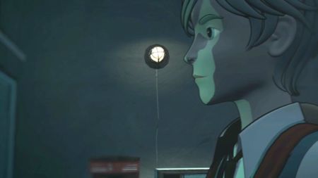 A young man looking at something in a dark room