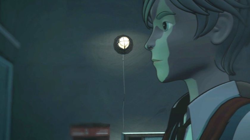 A young man looking at something in a dark room