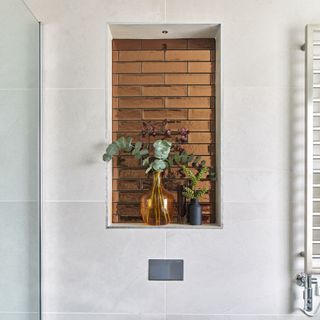 niche shelving in bathroom with wood panelling