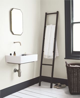 Dulux Rock Salt, the best light grey paint for small spaces, used in a modern minimal bathroom with a wall ladder, sink and mirror
