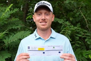 Hayden Springer shows off his scorecard of 59 at the 2024 John Deere Classic