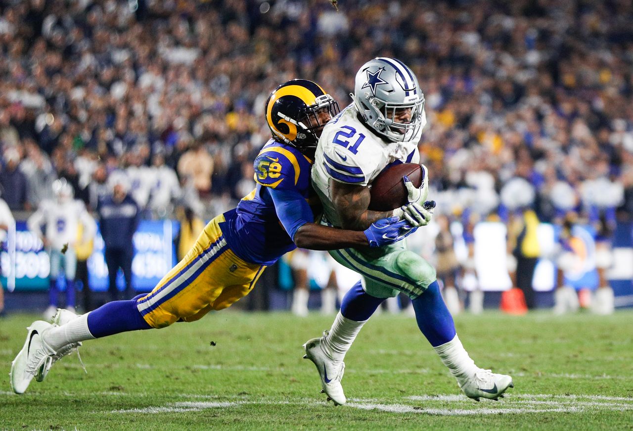 Inside linebacker Cory Littleton #58 of the Los Angeles Rams tackles running back Ezekiel Elliott #21 of the Dallas Cowboys.