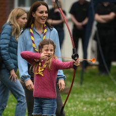 Princess Charlotte and Kate Middleton practice archery together, with Charlotte shooting a bow and arrow