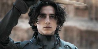 Timothée Chalamet as Paul Atreides in Dune holding up a knife