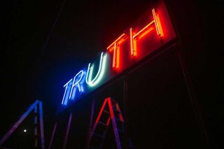 Stefan Brüggemann’s double-sided neon installation ’Truth / Lie’, installed on the roof of The Tunnel House in Tijuana, Mexico, overlooking the US/Mexico border