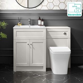 A bathroom vanity unit, finished in light grey with shaker-style cabinet doors and chrome handles. It incorporates a white ceramic sink with a chrome mixer tap.