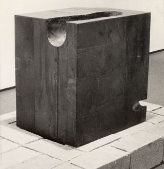 Black and white image of a block with sections carved out of it