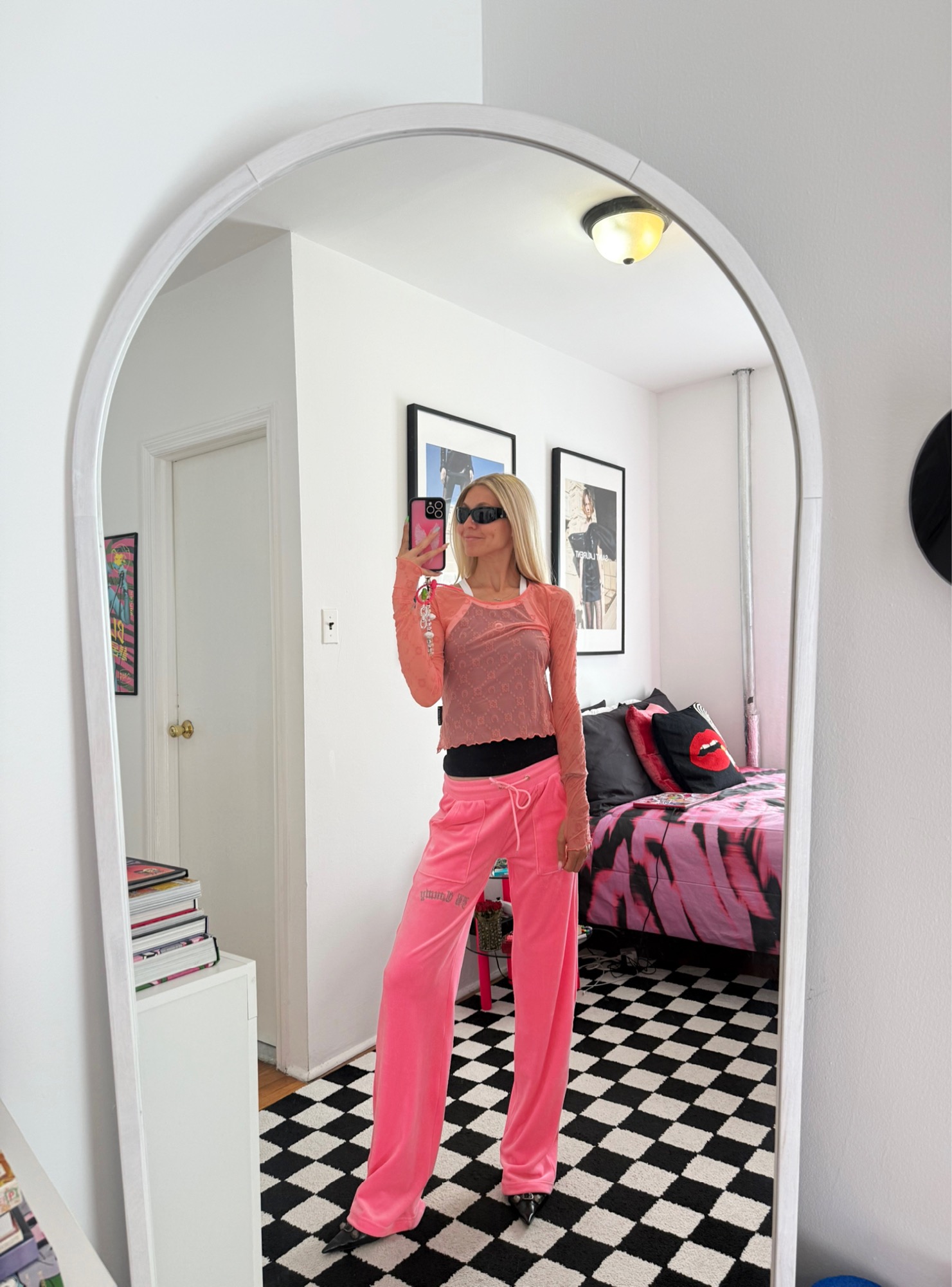Jessica Minkoff posing in mirror wearing pink t-shirt and pink sweatpants