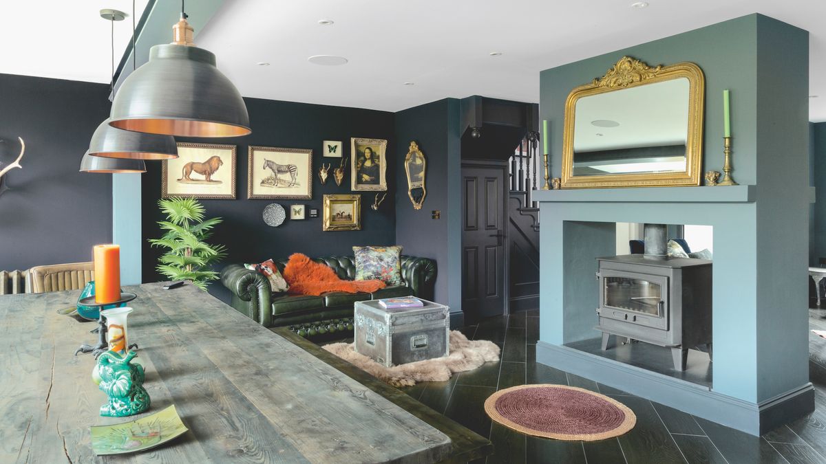 A centrally situated fireplace containing a double-sided Clearburn wood-burning stove zones the dining area from the rest of the open-plan space, while the timber-effect ceramic tiles &ndash; in London Black to contrast with the kitchen area &ndash; have been laid diagonally throughout.