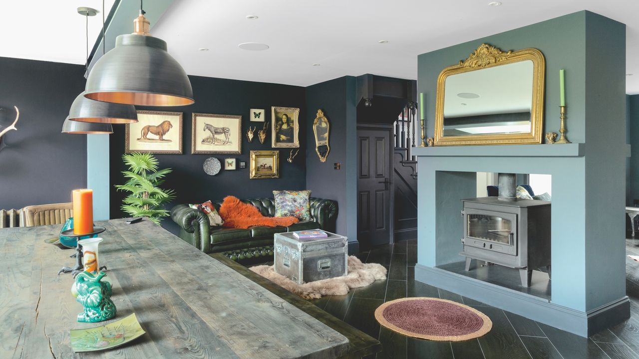 A centrally situated fireplace containing a double-sided Clearburn wood-burning stove zones the dining area from the rest of the open-plan space, while the timber-effect ceramic tiles &ndash; in London Black to contrast with the kitchen area &ndash; have been laid diagonally throughout.