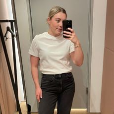 Woman wears white t-shirt and black jeans 