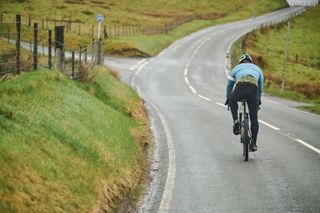 Cyclist climbs away from the camera