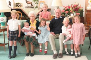 Queen Elizabeth II and Prince Philip, Duke of Edinburgh pose with their great grandchildren (L-R) Prince George, Prince Louis being held by Queen Elizabeth II, Savannah Phillips (standing at rear), Princess Charlotte, Prince Philip, Duke of Edinburgh, Isla Phillips holding Lena Tindall, and Mia Tindall in 2018 in United Kingdom. (Photo by The Duchess of Cambridge via Getty Images)