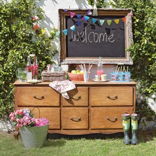 garden with welcome note on chalkboard