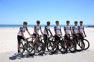 The Dimension Data pose for photos on the beach