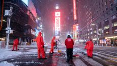 New York City workers shovel snow in Times Square amid a large snowstorm.