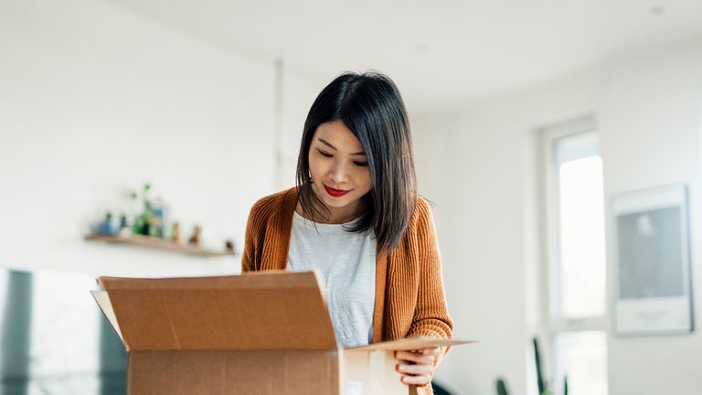 woman opening box