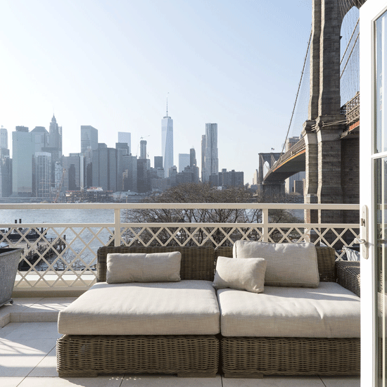balcony with sofaset and multistoried buildings in background