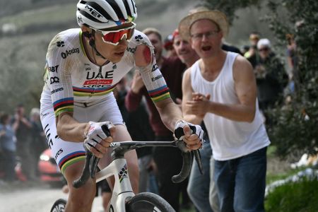 Team UAE's slovenain rider Tadej Pogacar rides as he sustains an injury on his arm after a crash during the 19th one-day classic Strade Bianche (White Roads) men's cycling race between Siena and Siena in Tuscany on March 8, 2025. (Photo by Marco BERTORELLO / AFP)