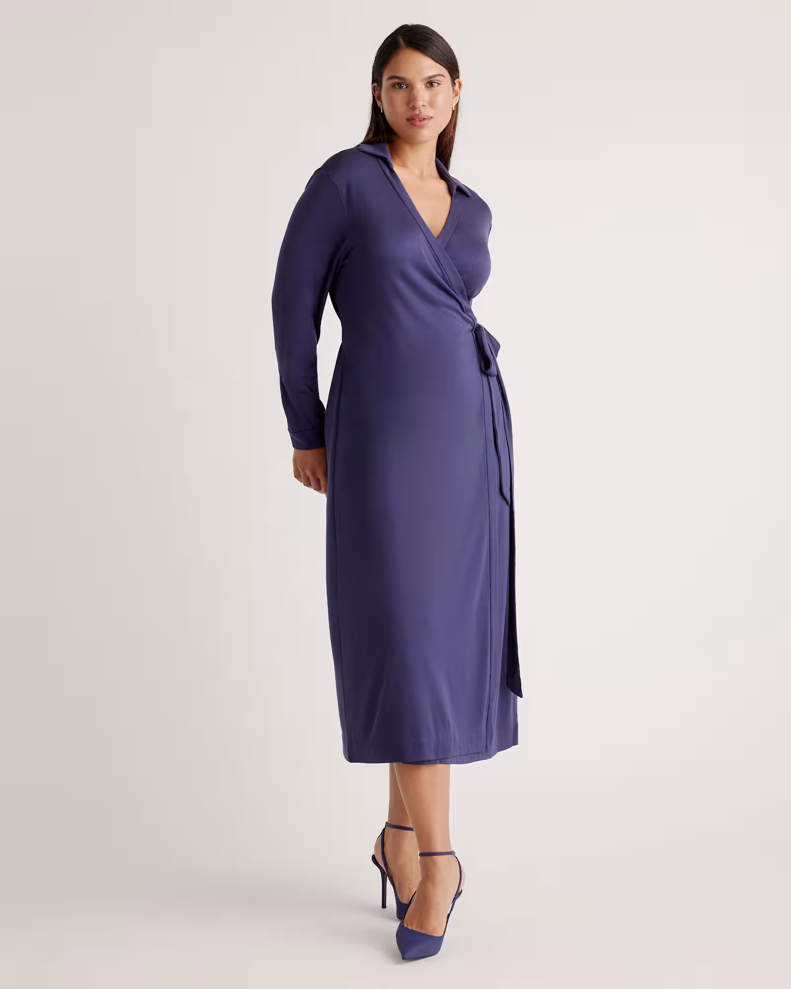 A model wearing a blue wrap dress