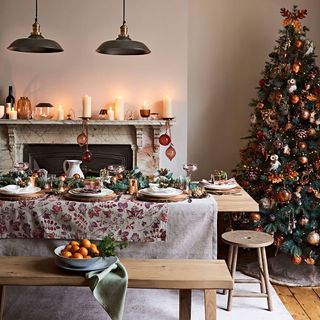 room with wooden flooring white wall and christmas tree