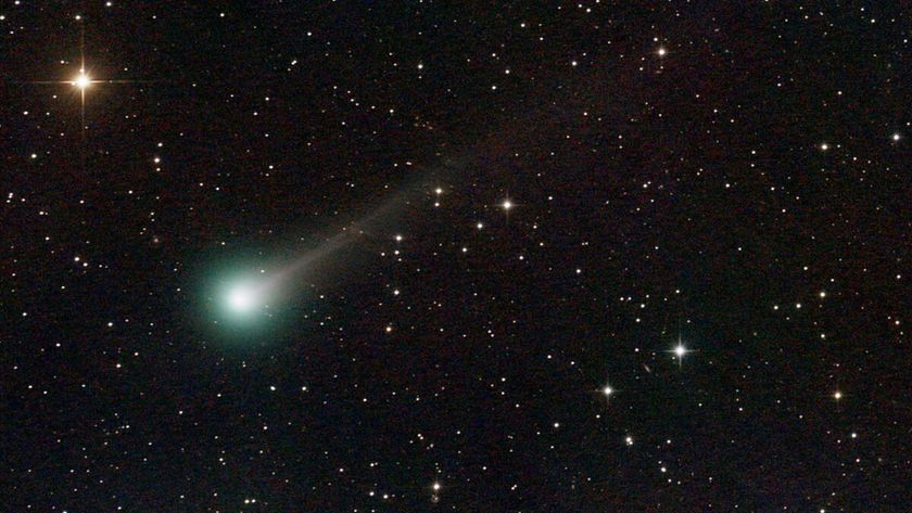 A photo of Comet Lemmon with a green glow around its nucleus and a long glowing white tail
