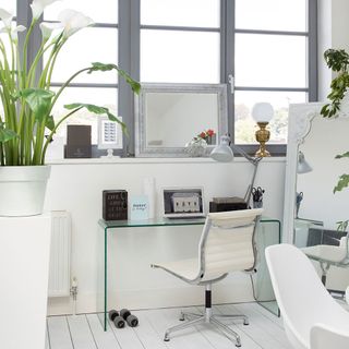 home office with work desk chair and artificial plants