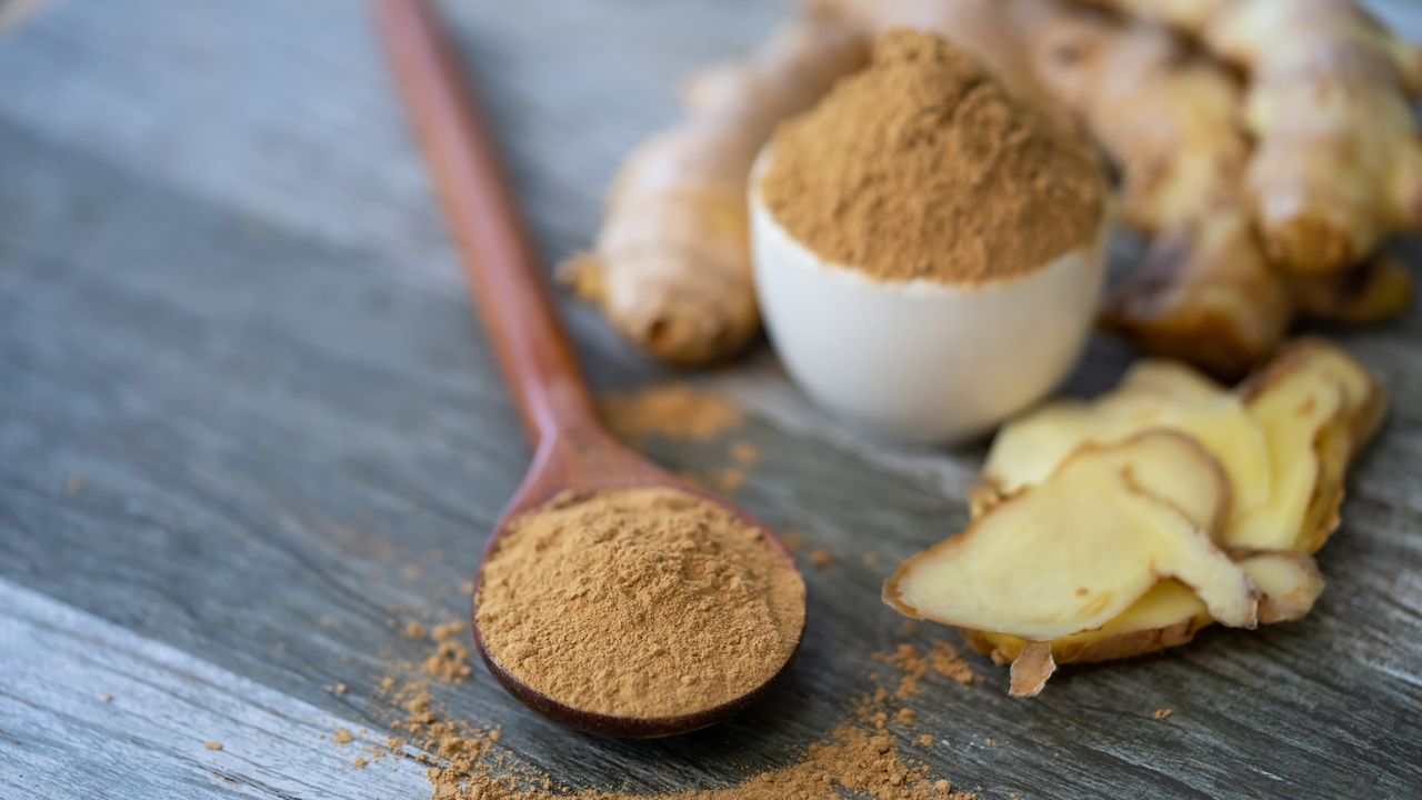 Powdered and fresh ginger on a chopping board