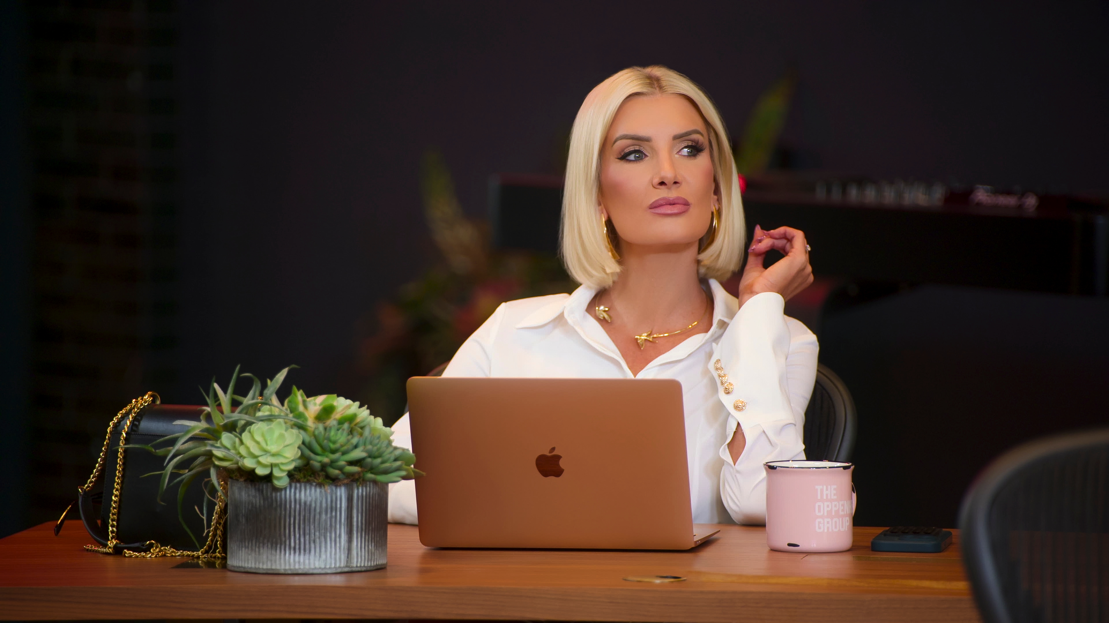 Nicole Young sits at her desk and laptop in a still from selling sunset season 9