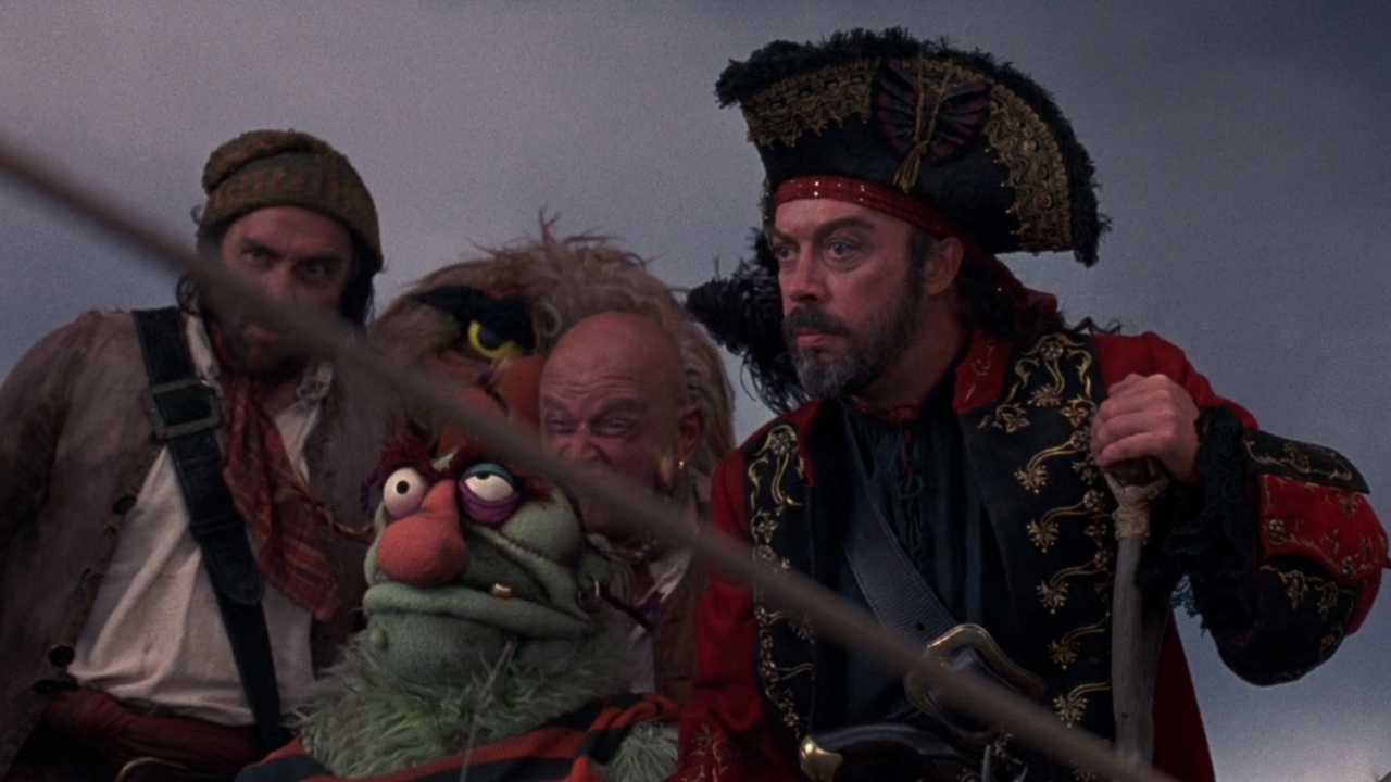Tim Curry stands with his pirates in Muppet Treasure Island.