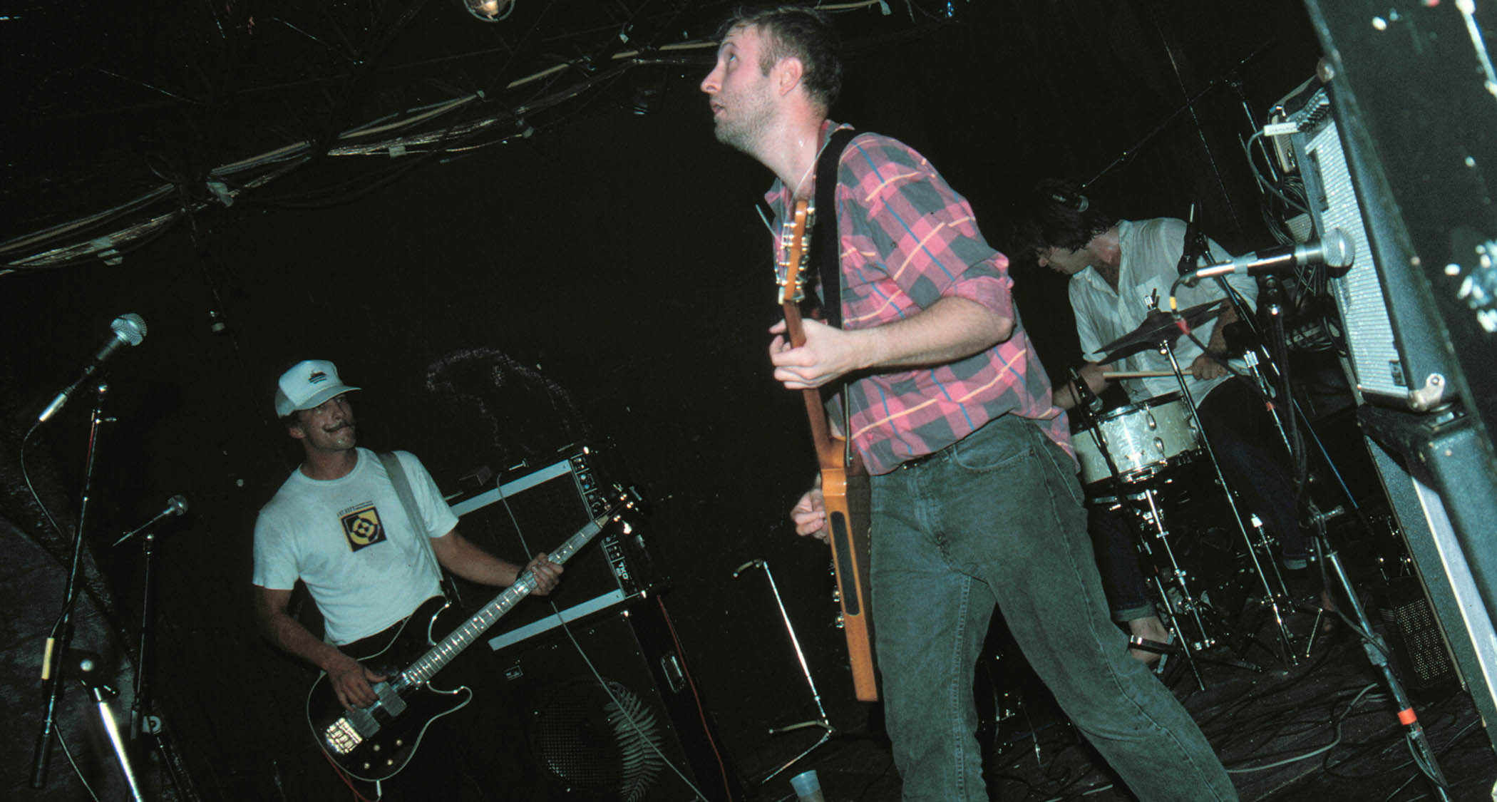 Hüsker Dü play live in the mid &#039;80s, with Bob Mould playing a Flying V and wearing a pink and gray plaid shirt.