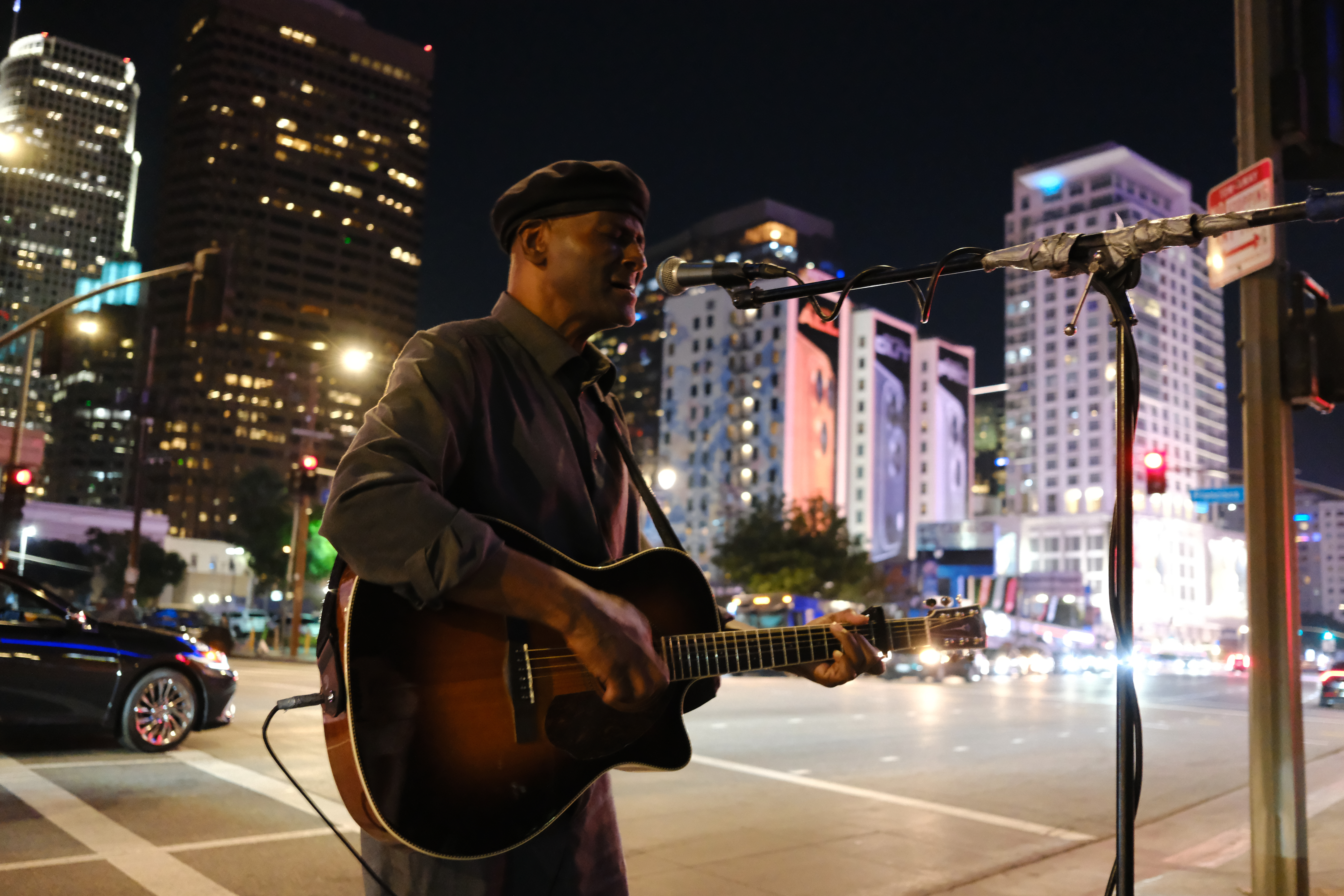 A musician plays guitar on the streets of downtown Los Angeles, taken with the FUjifilm XF 23mm f/2.8 R WR and X-E5