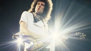 Brian May playing a Gibson Flying V onstage during the Hot Space Tour 1982
