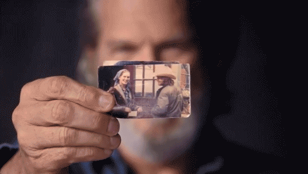 Jeff Bridges holds up his "prized possession", two photographs of his wife from the moment they met