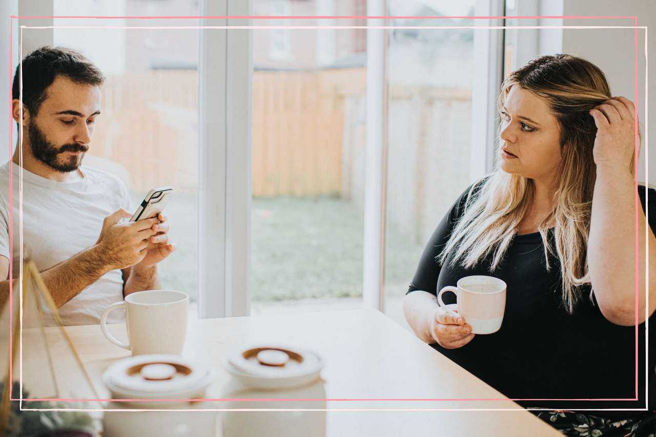 couple sat at table, man is ignoring woman