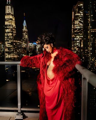 Cardi B wearing a red fur coat and red gown in manhattan