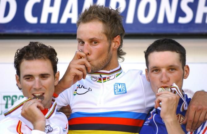 Tom Boonen (Belgium) kisses his gold medal on the podium while Alejandro Valverde (Spain) and Anthony Geslin (France) have to be content with silver and bronze