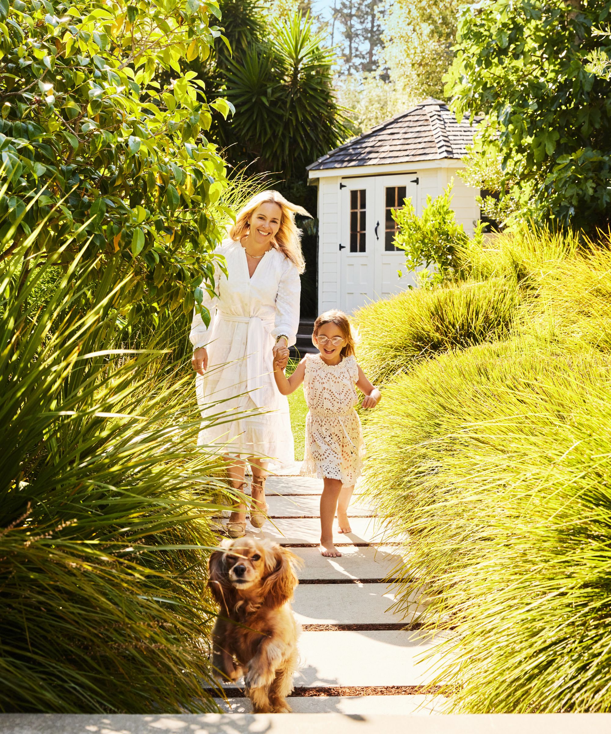 Anyon Brier with her daughter and dog the garden.