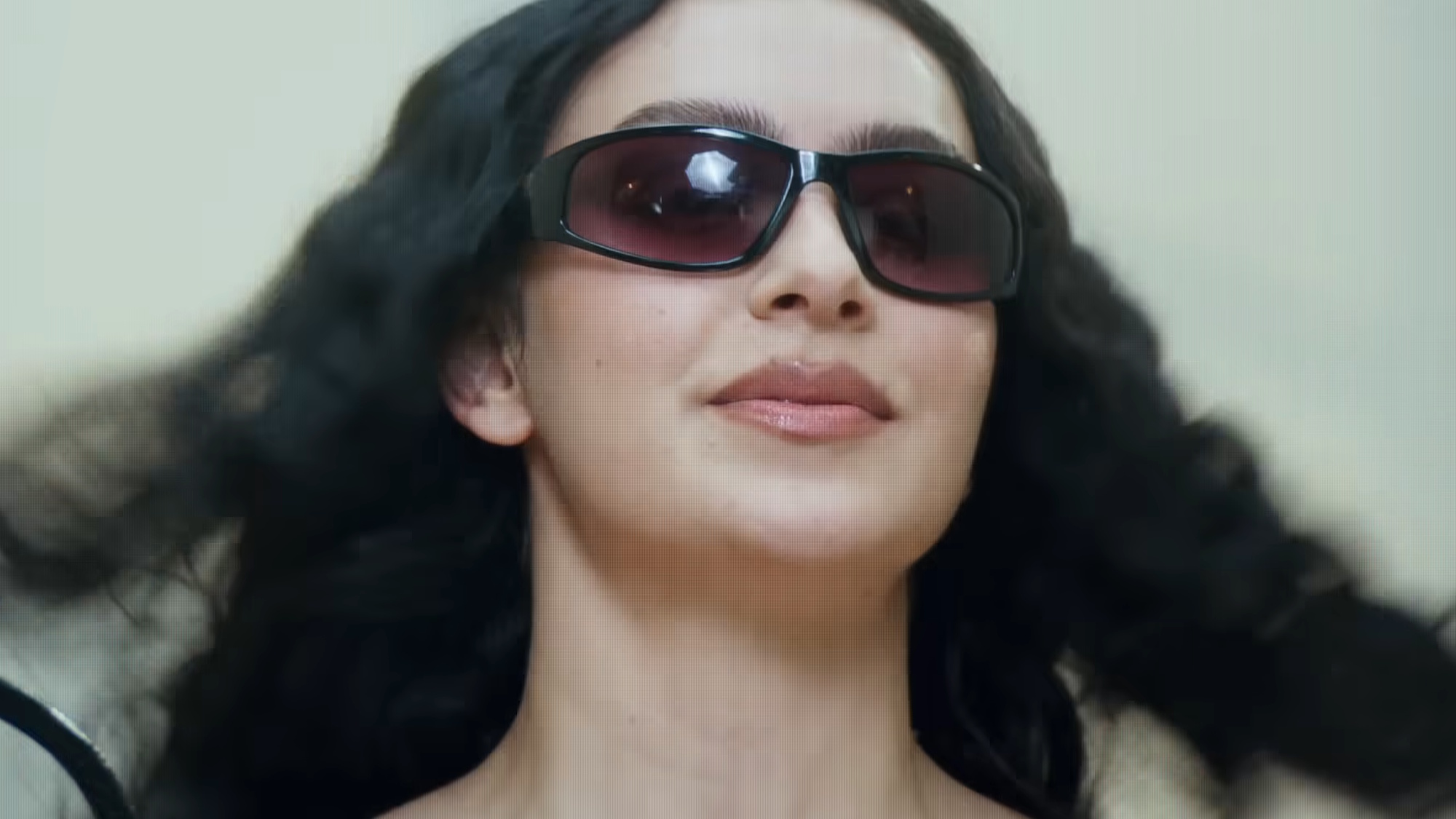 Charli XCX is shown in The Moment.