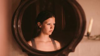 Mia Goth reflected in a mirror in X.