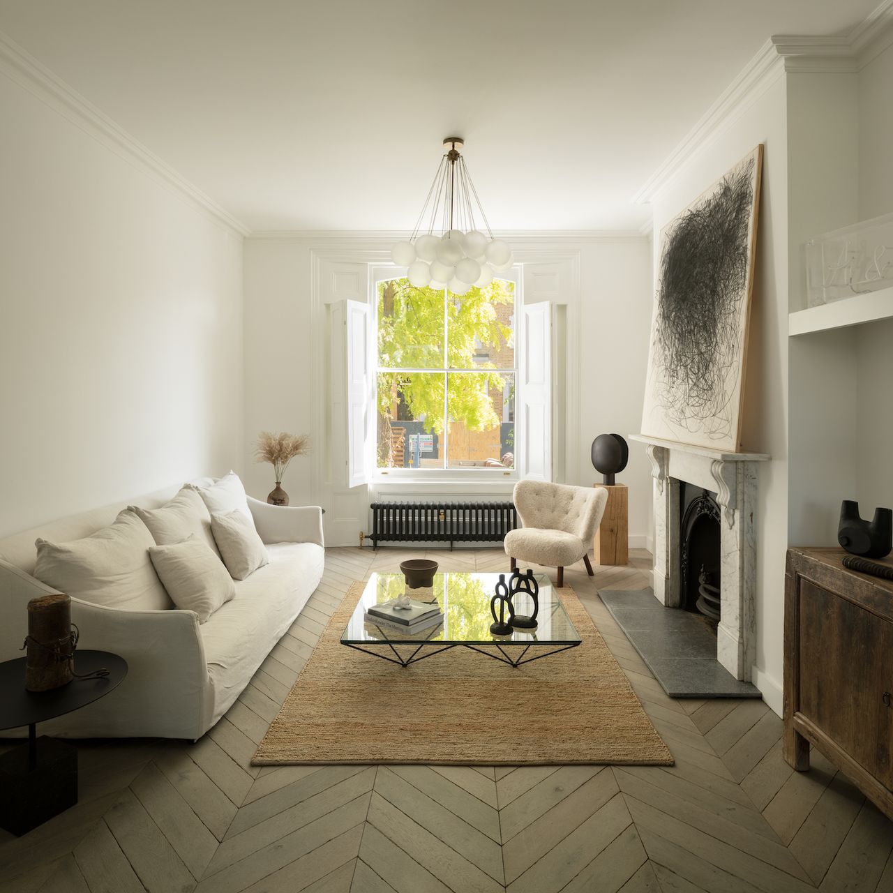 Minimalist living room with a cream sofa, rug and fireplace