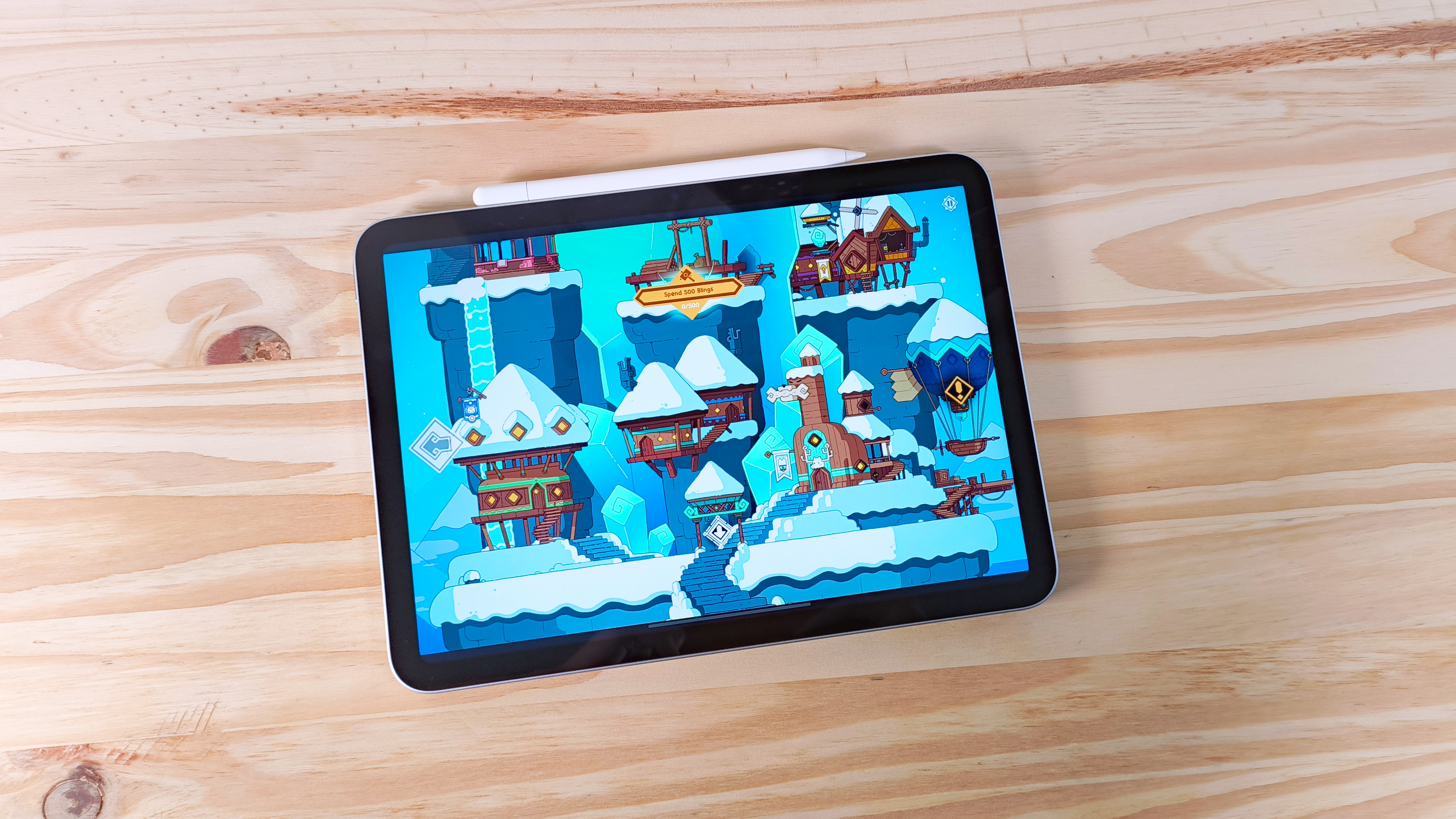 The iPad 11 running the game Wildfrost seen from above on a wood table